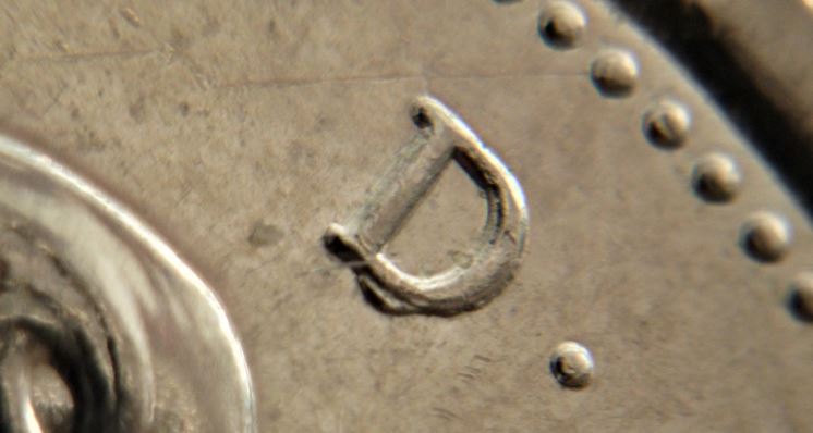 25 Cents 2006-Éclat du coin sous D de D.g-2.JPG