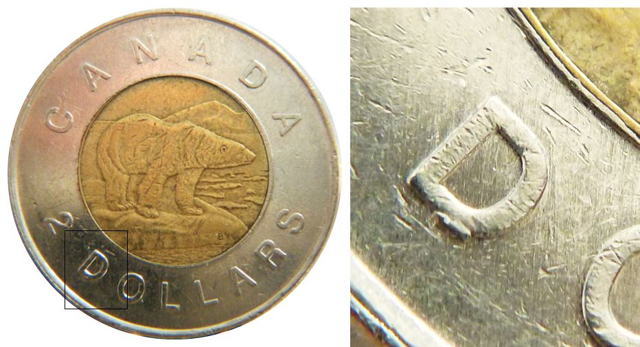 2 Dollars 2002-Éclat coin sous D de Dollars-No.1.JPG