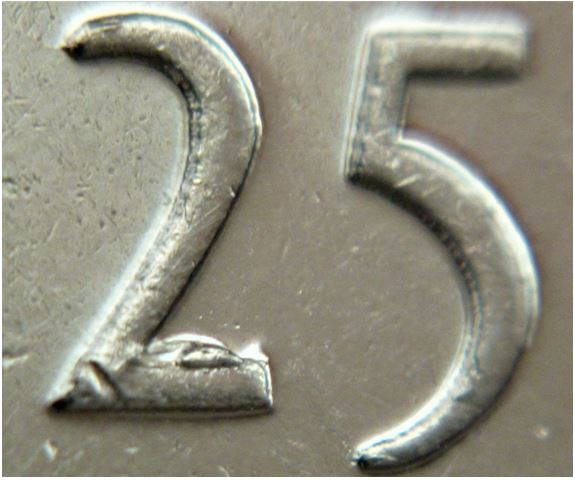 25 Cents 2010-Éclat coin sur patte 2 de 25-2.JPG